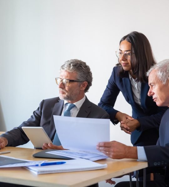concentrated-partners-using-laptop-working-with-documents